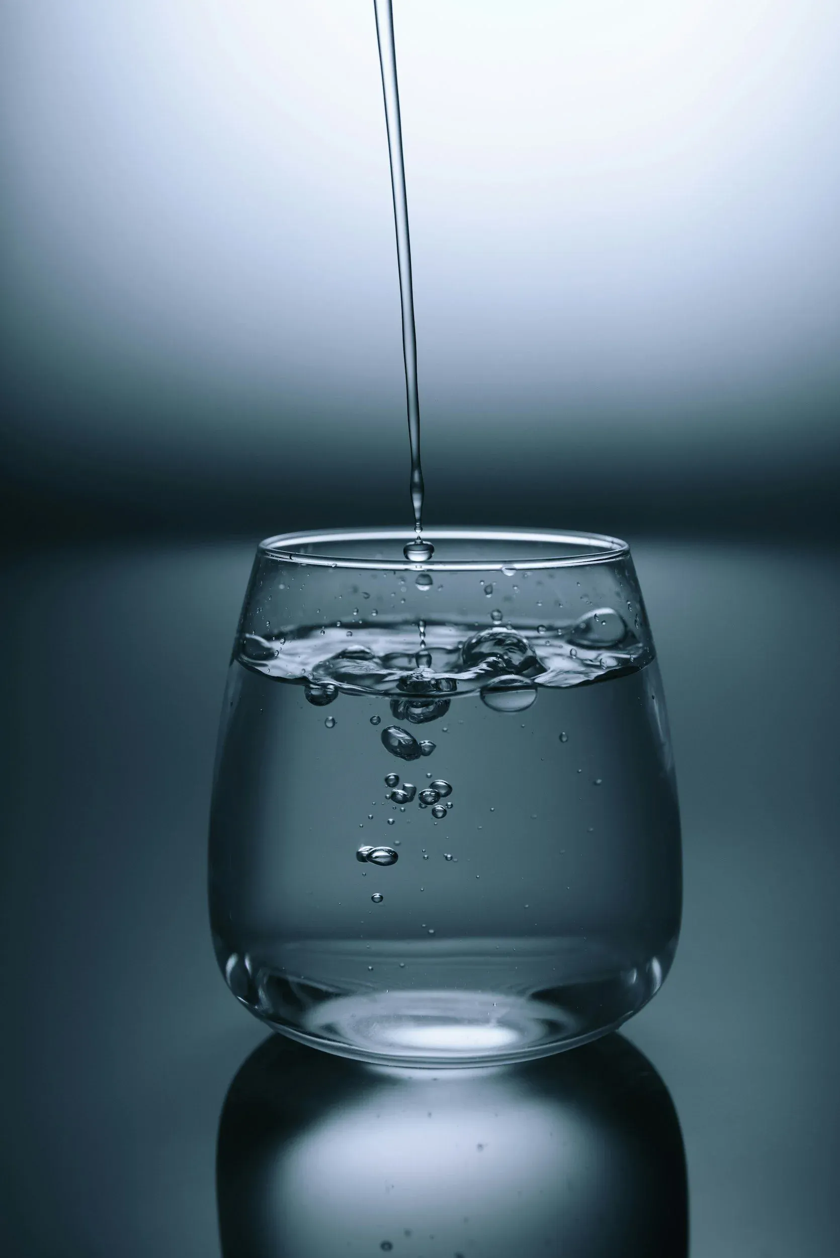 Water pouring into a glass at a kitchen tap